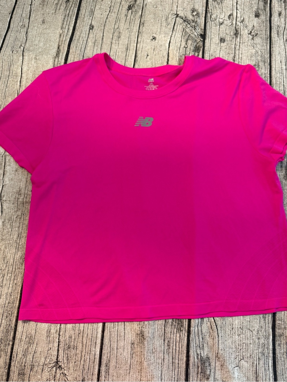 NEW. New Balance cropped work out tee. New, never used. Dry breathable fabric